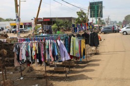 Displayed wares of a second-hand clothes trader displayed along the main Karen roadway